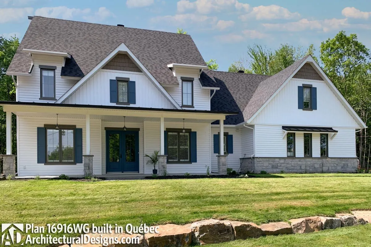 A modern farmhouse constructed in Quebec is beautiful throughout the day.