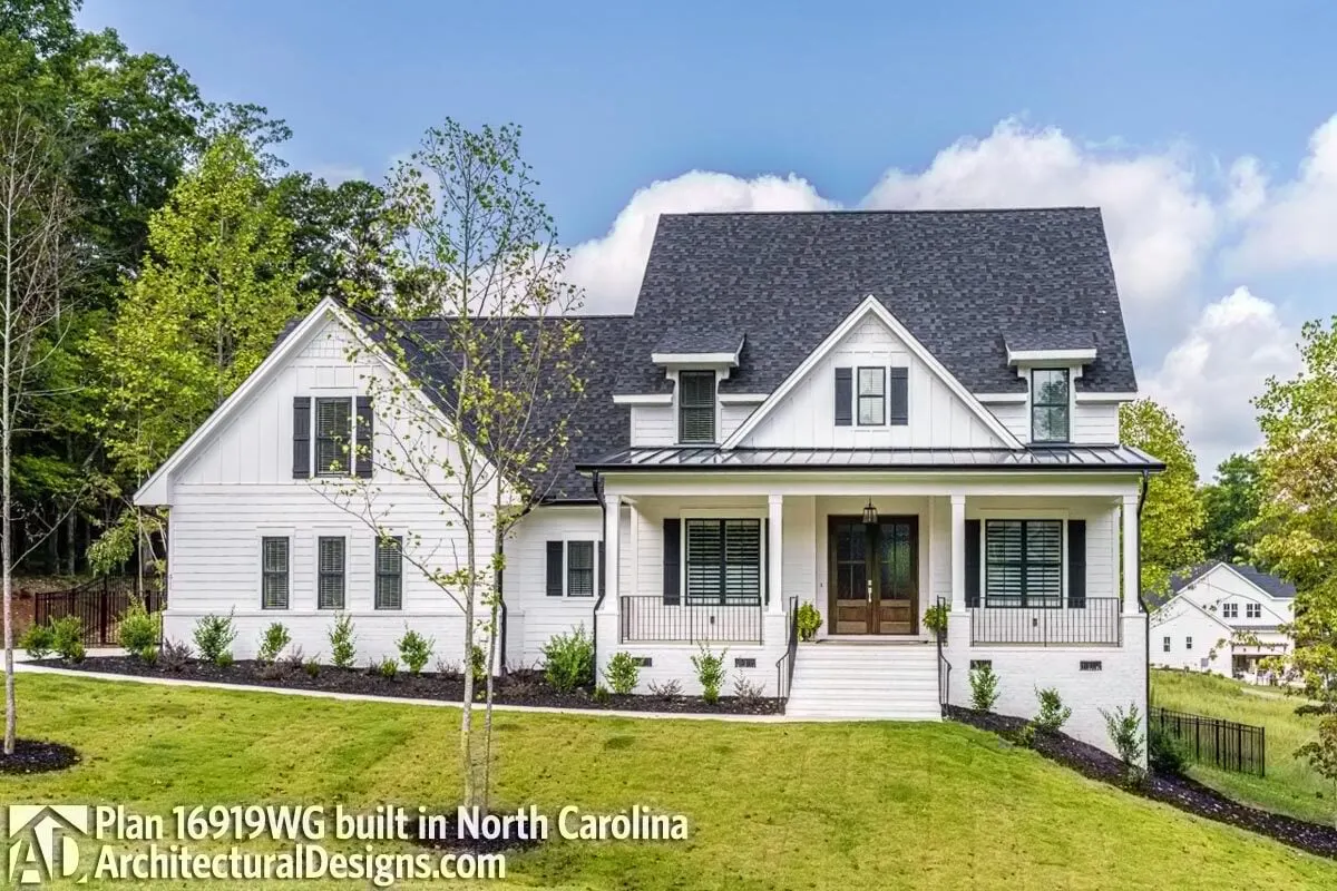 A modern farmhouse built on sloped land in North Carolina.