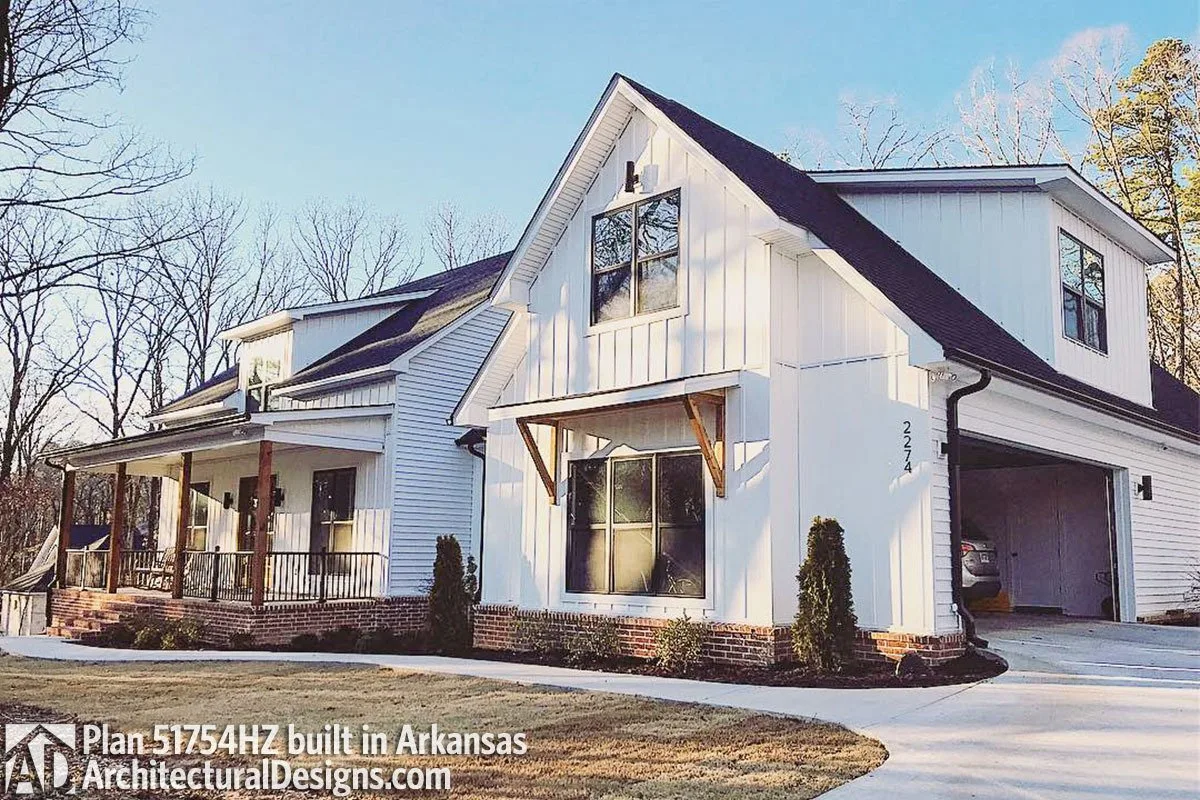 A closer look of the farmhouse with a side car garage entry.