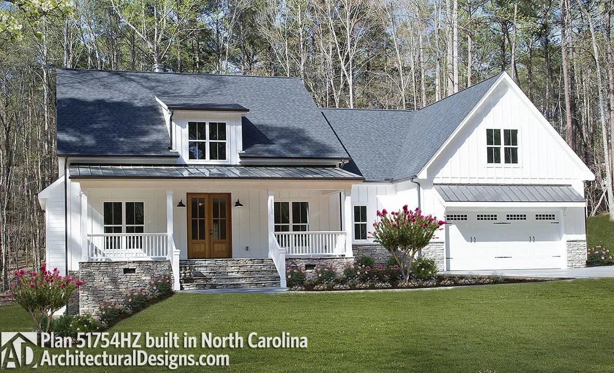 A much more clearer view of the modern farmhouse with a wooden door, staircase to the entry porch, and side car garage instead of bonus room.