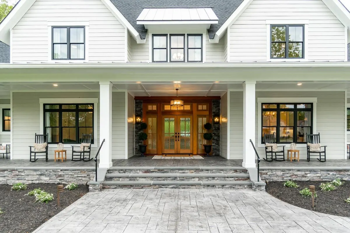 A more in-depth look at the covered entry porch as well as the stairway that leads up to the french door.