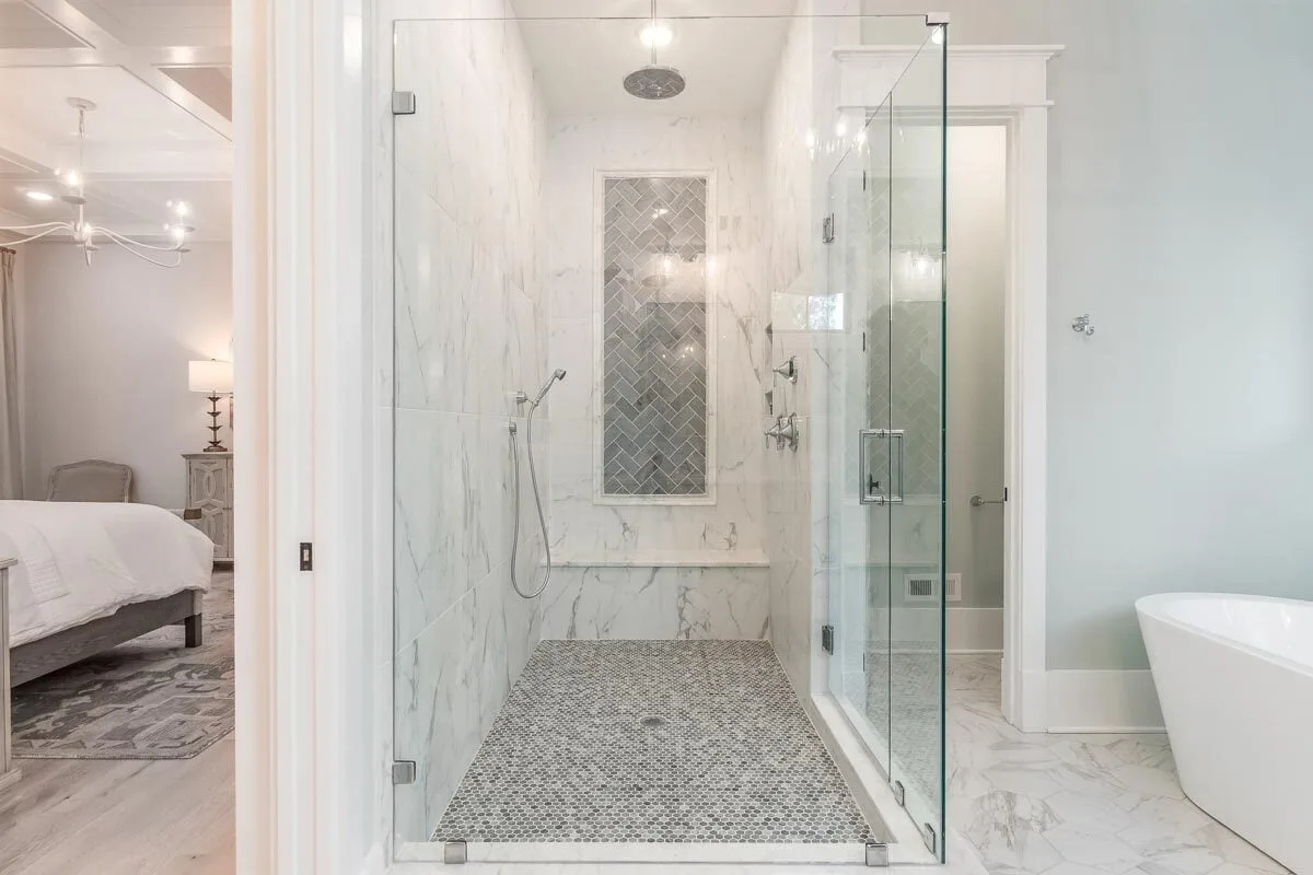 A glass-doored en suite bathroom with a shower in the master suite.