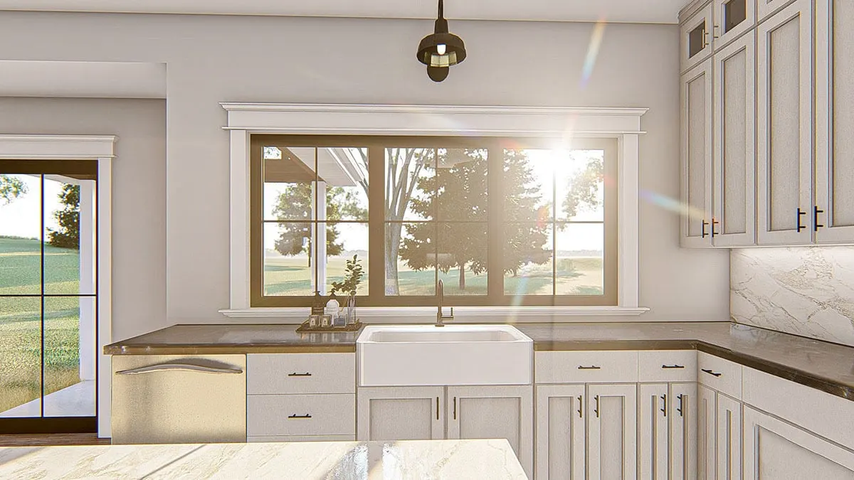 The kitchen area The kitchen has a countertop and sink in a modern design and a window with a view of the outside.