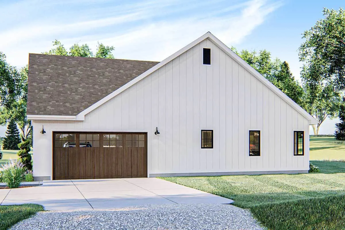 The wooden garage door The wooden garage door with a large driveway is seen on the right side.