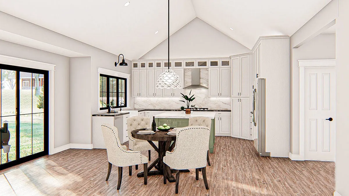 Dining space  Featuring a wooden accent table and chairs, the dining space looks out into the covered patio.