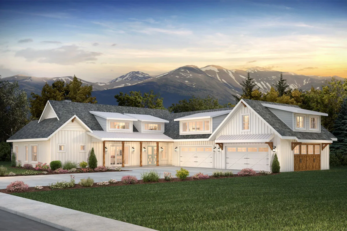 A modern farmhouse looks beautiful at night when viewed from a road.
