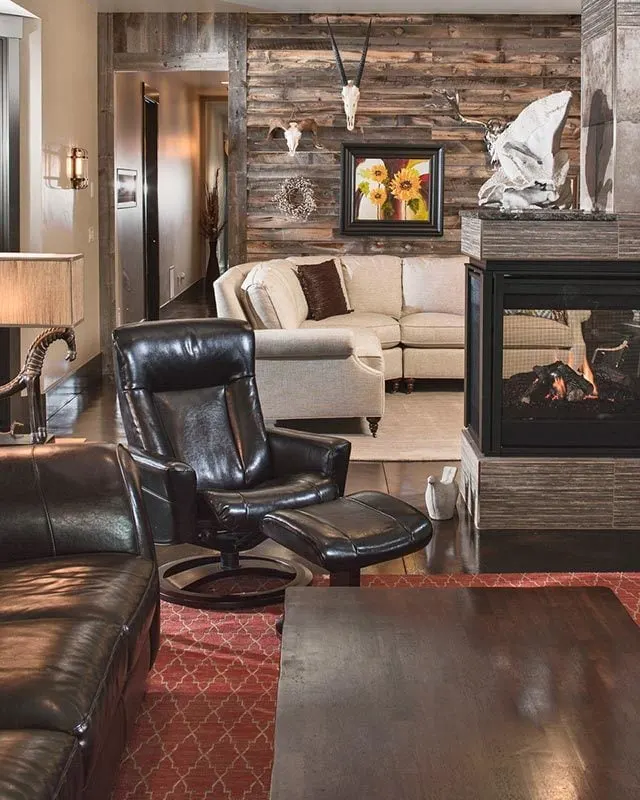 A great room space with two couches placed up near the fireplace.