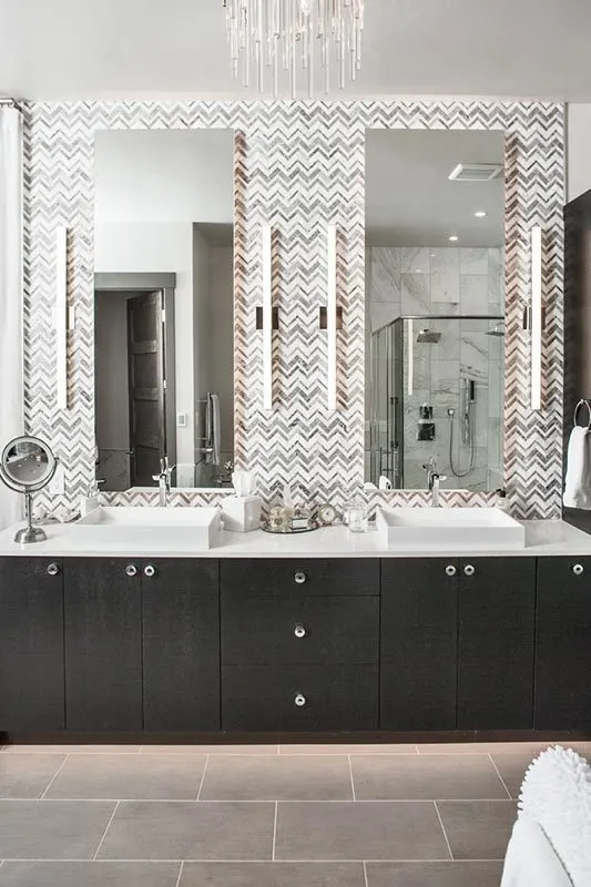 Vanities with zigzag backsplashes and tubing lights.