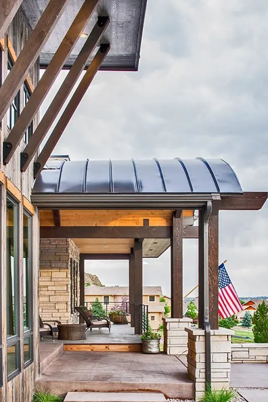 Front porch with an attractive open space under an arched ceiling.