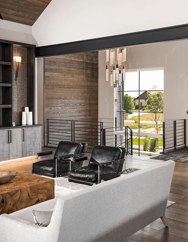 The black leather seats match the stair railing behind it.