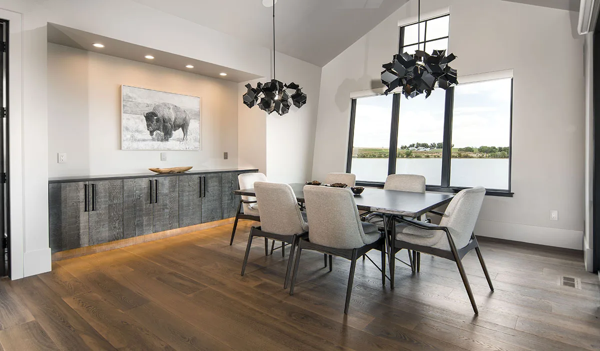 The dining room is still black and white with a great view of the outside.