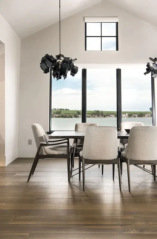 The house's spacious dining space features a one-of-a-kind black chandelier design.