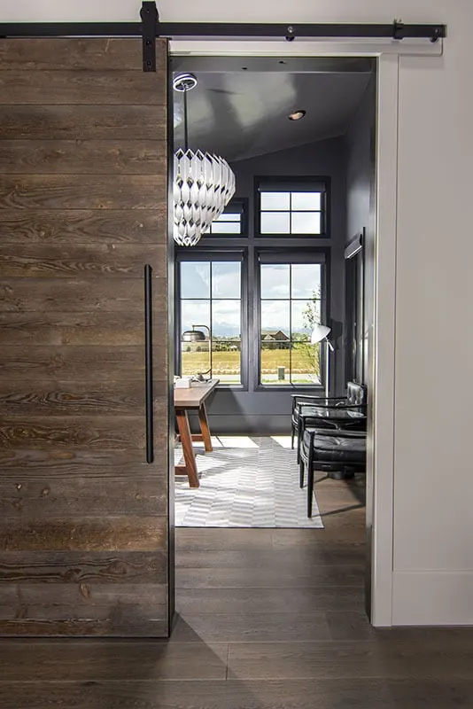 A barn-style door is used in the home's office area.