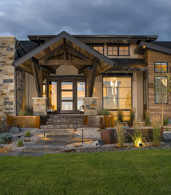 The front porch of the home, with stone stairs leading to the main door.