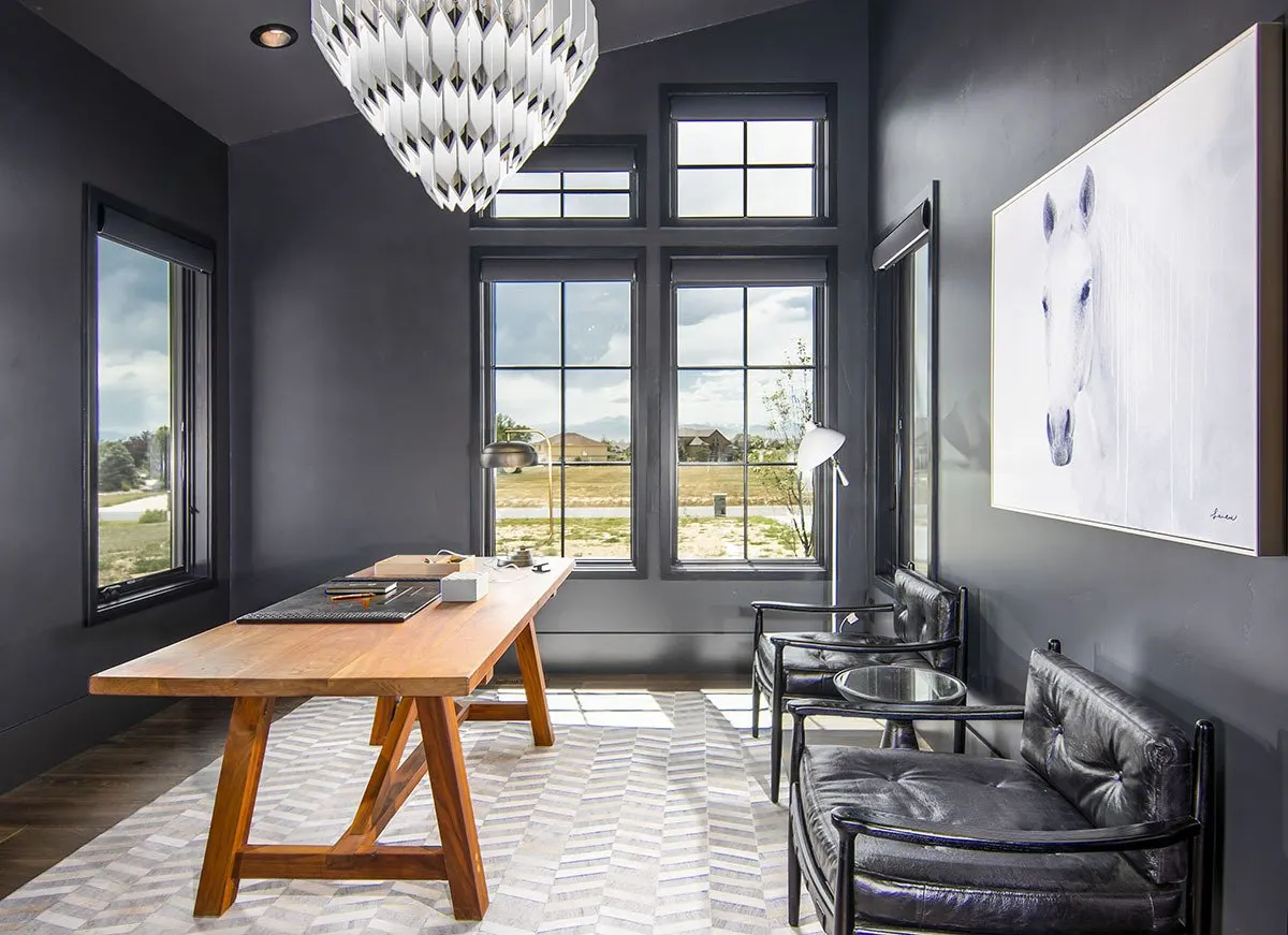 The workplace area has a dark color scheme with a noticeable wooden accent table.