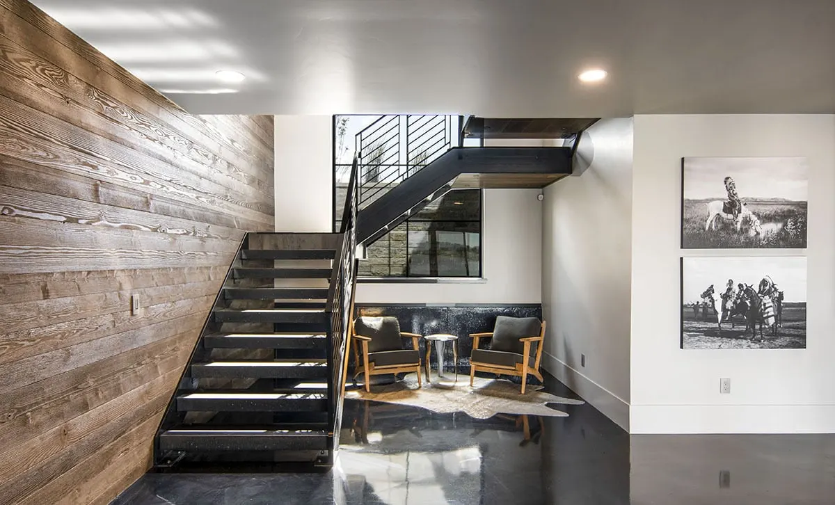 A black stairwell with a black accent lounge area beneath seems classy.