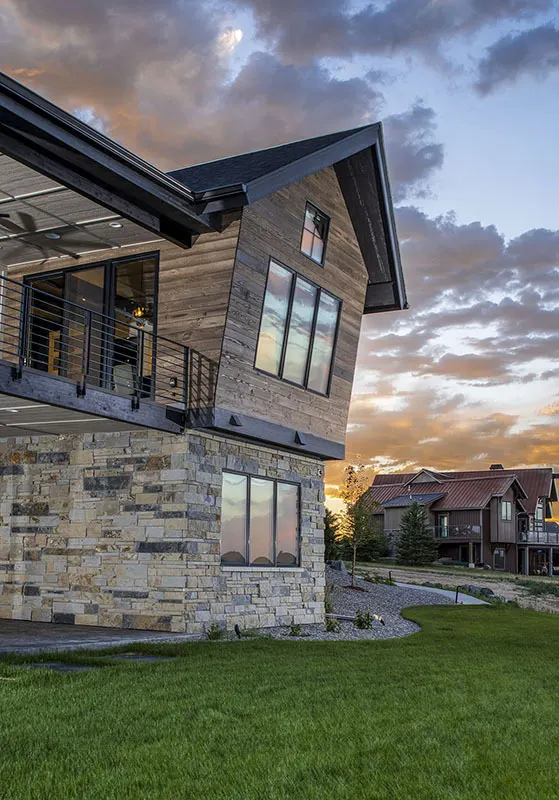 Modern mountain house with an obvious fall-down wooden area on the second story.