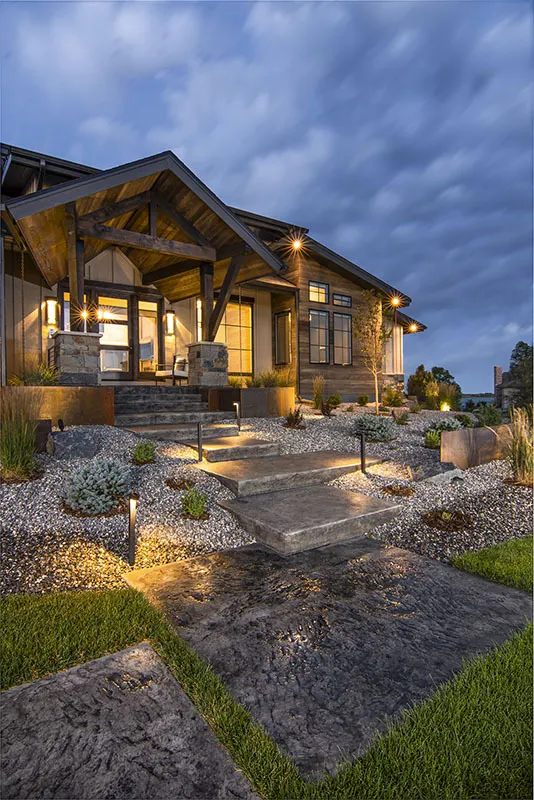 The main entrance of the home is reached through a large walkway steps from the yard.