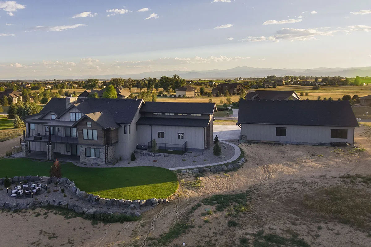 Back aerial view of the house amid a gorgeous large yard scenery.
