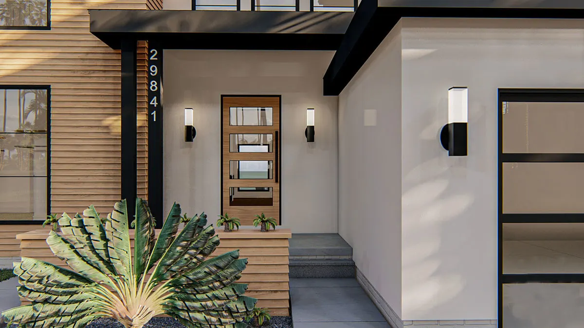 The porch of the house has a black pillar and roof that matches the subtle touch of paint on the walls.