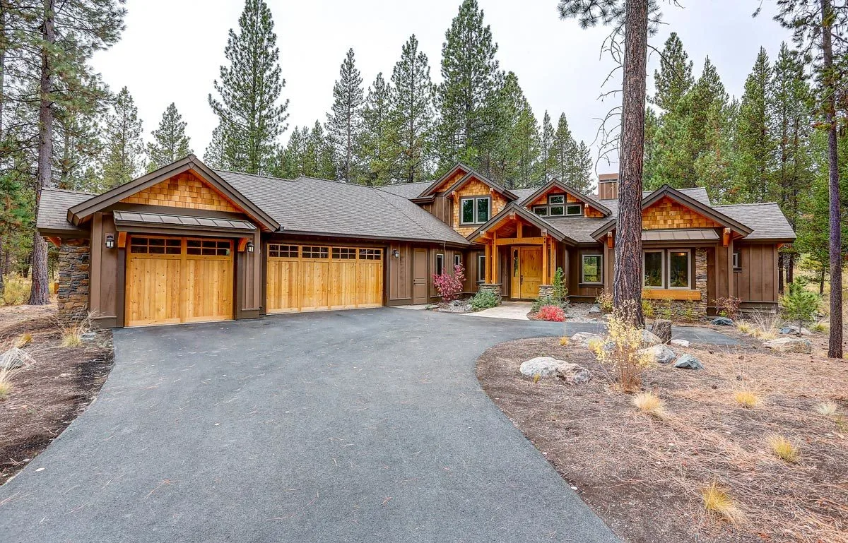 Three-car front garage with a wooden design door.