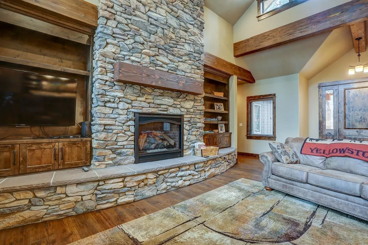 The fireplace's sturdy stone wall and base.