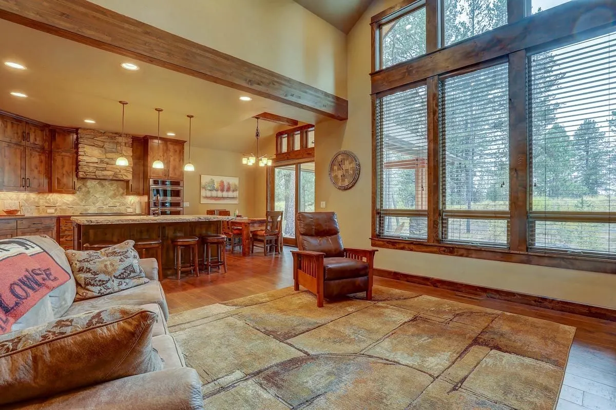 Beautiful and welcoming separate wooden leathered seat beside a window.
