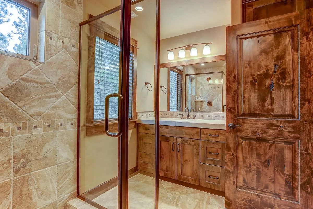 The master bathroom has a modern wooden design.