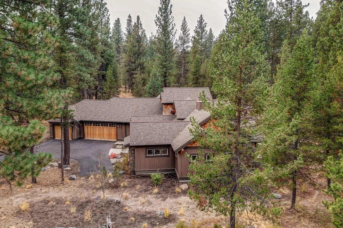 Aerial picture of the residence, which is bordered by mountainous forests.