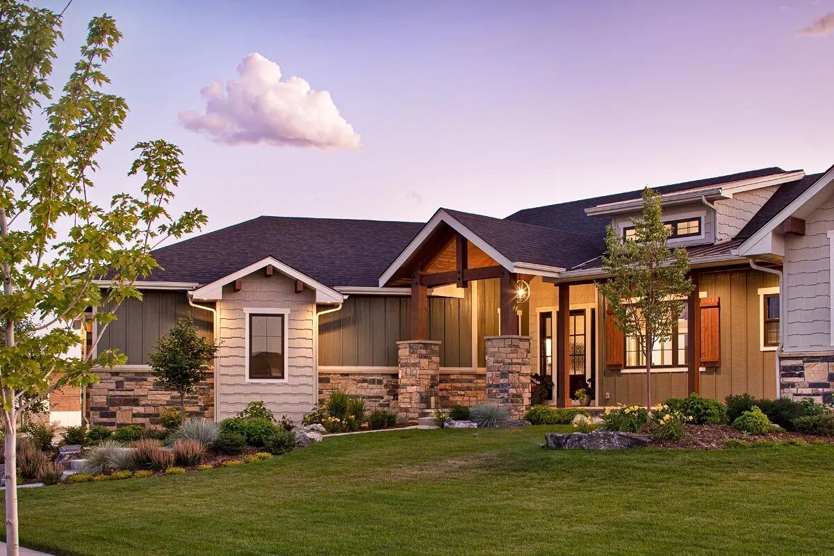 The entrance porch appears welcoming with its wooden accent design and window shutters.