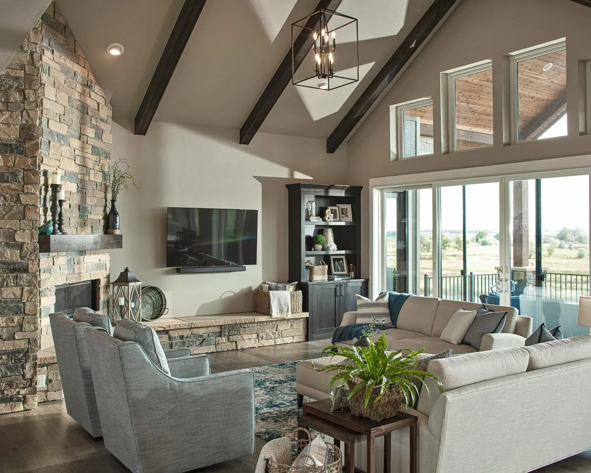 A modern look of a living area with a stone brick fireplace.
