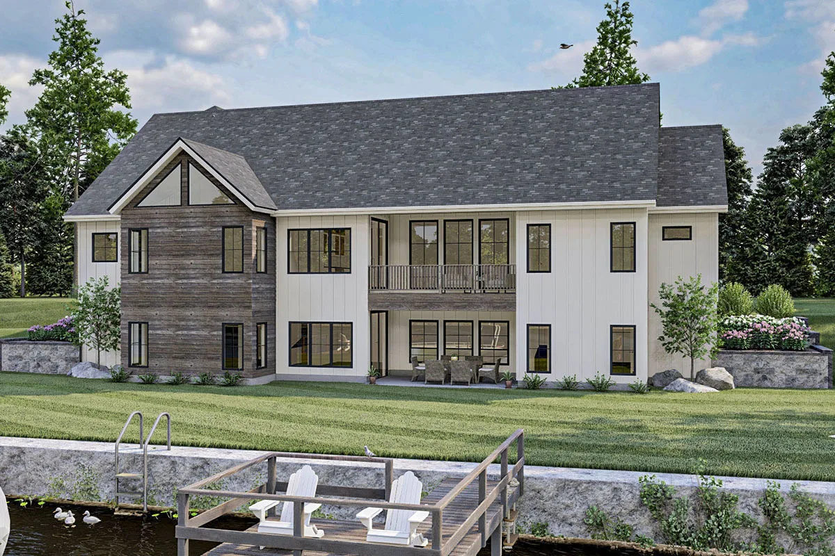 The exterior of the back part of the home is highlighted by large vertical glass windows.
