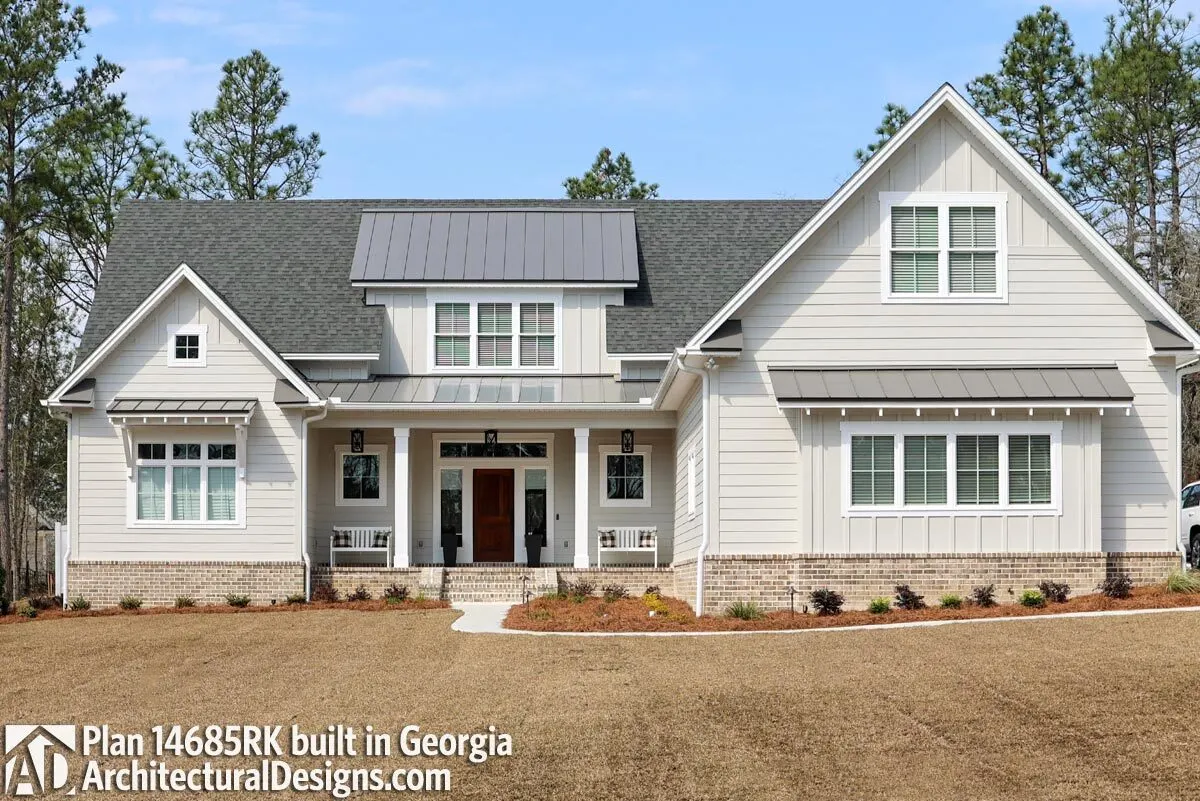 A bright rendition of the façade of a New American home with a barren yard.