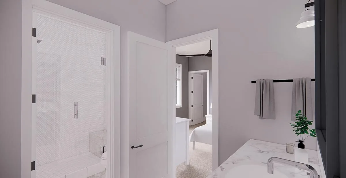 A bathroom featuring a glass-door shower and a marble-topped basin.