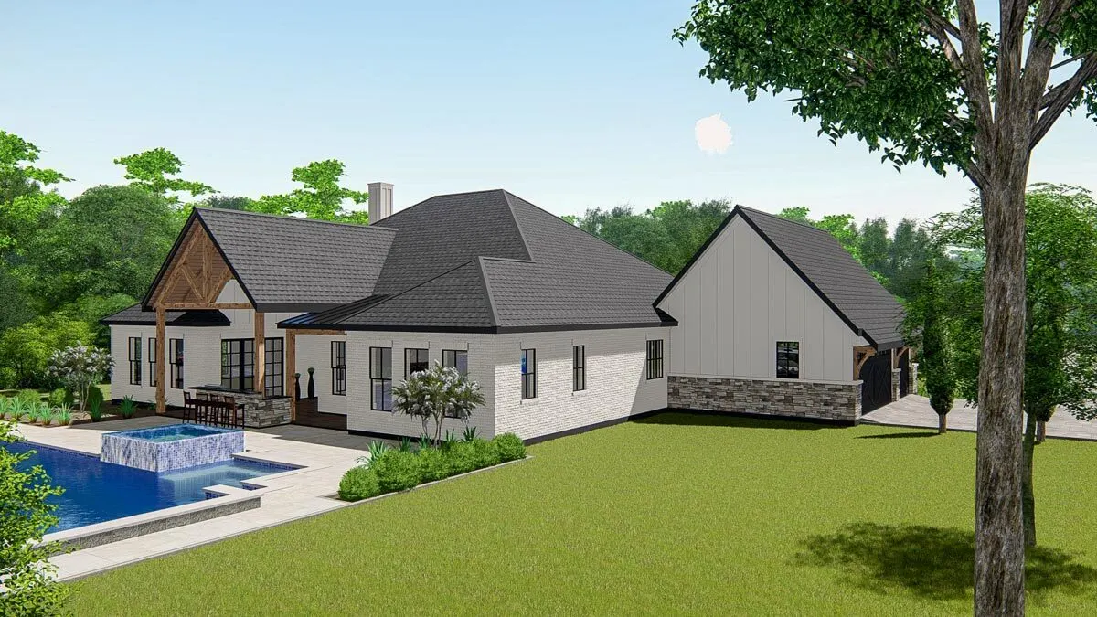 The back of the home has a large green yard with a landscape.