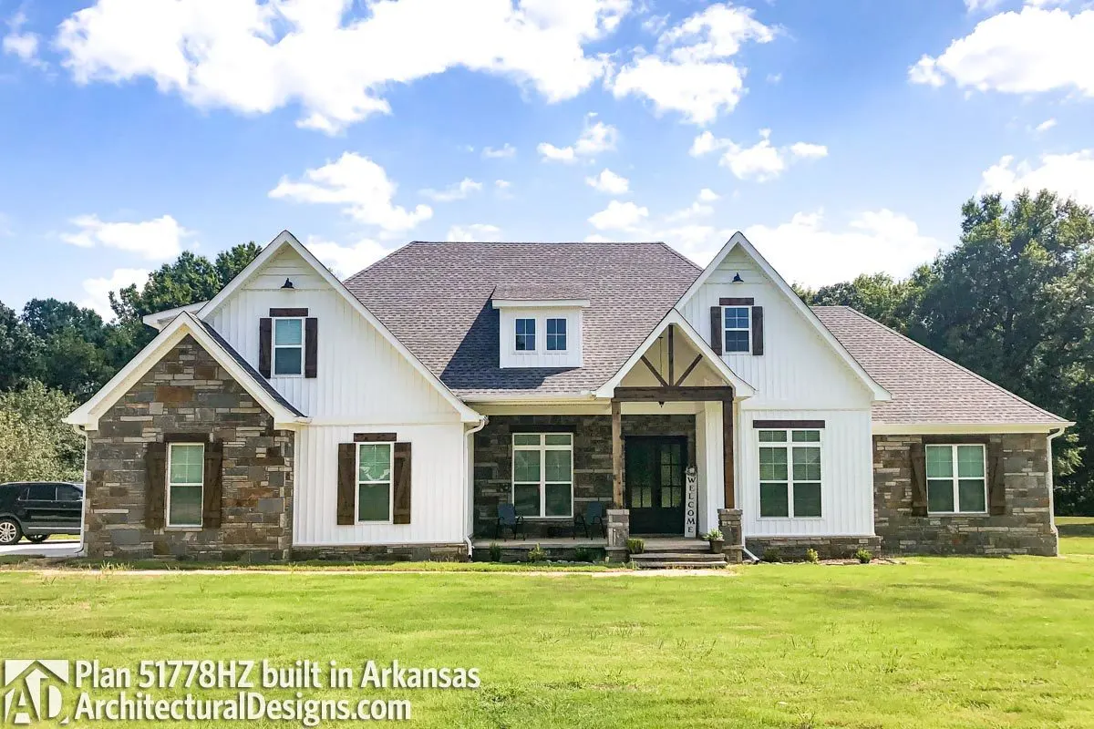 The glazed windows on this craftsman's house look great with the barn-style shutters and porch pillars.