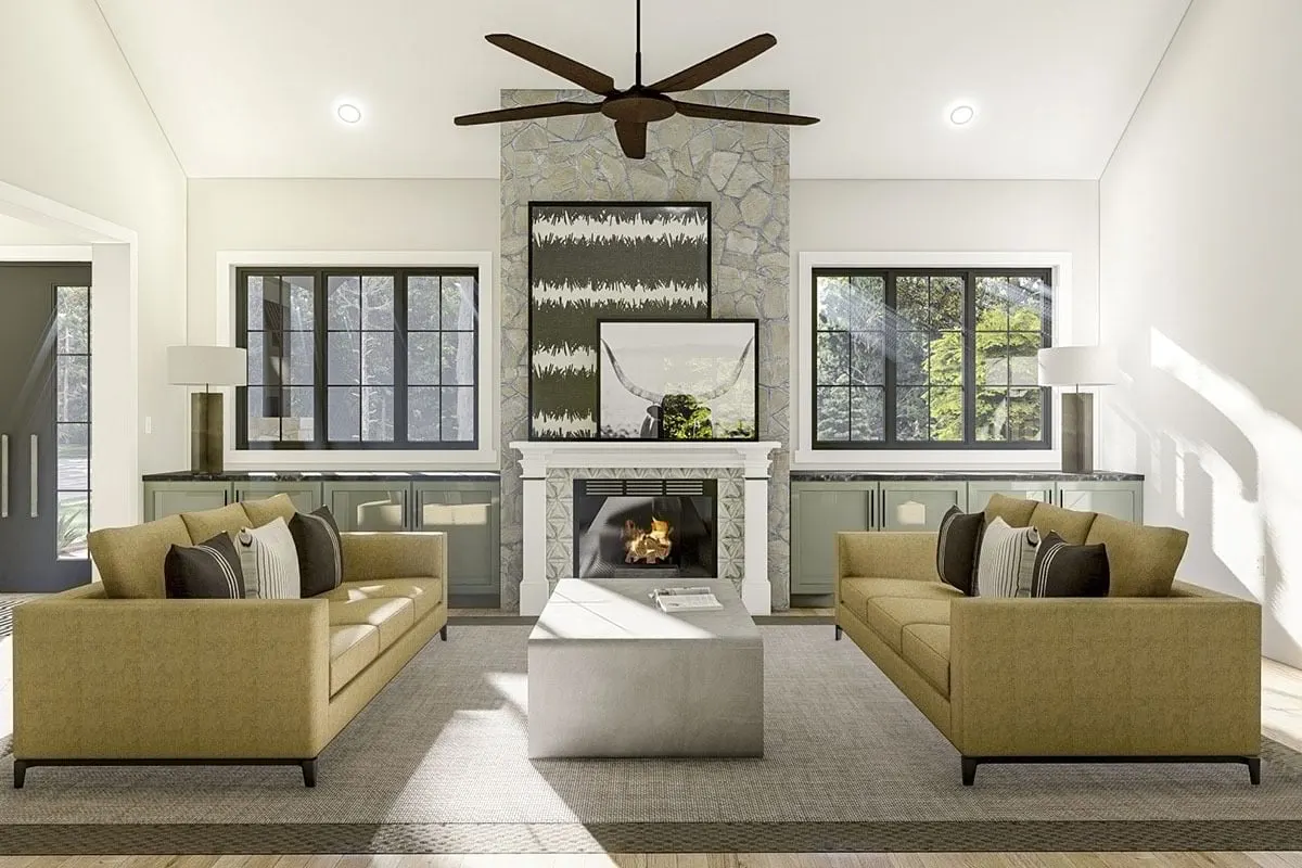 A viewpoint is taken from the main living area, which features a fireplace and a fan chandelier.