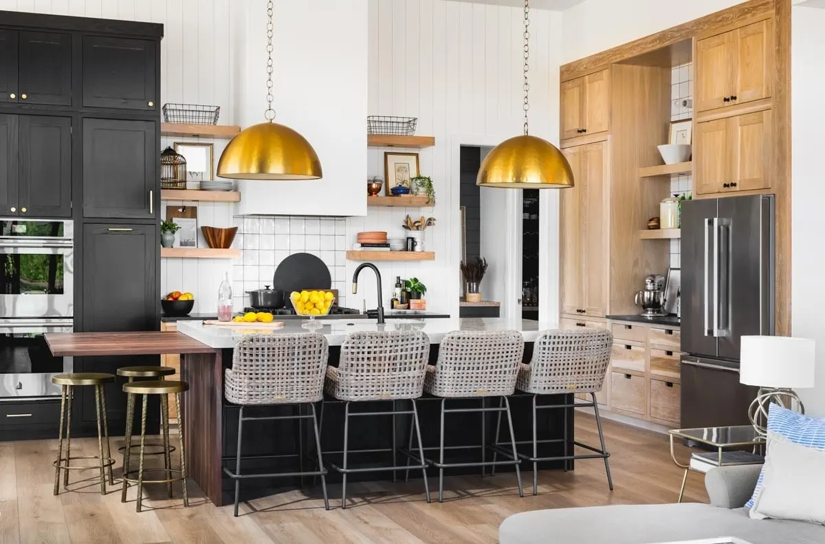 The wooden cabinets look amazing with the old chairs and lights.
