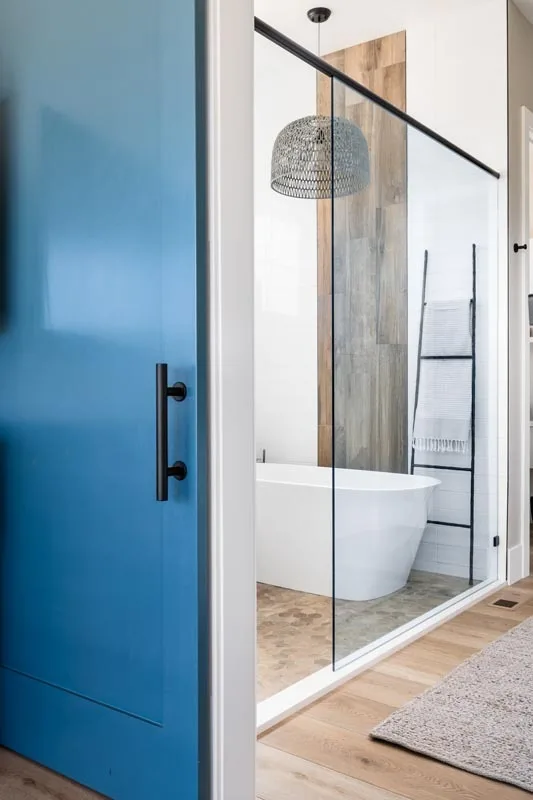 A glass-enclosed soaking tub is included in the bathroom.