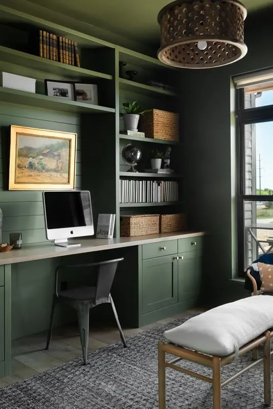 The office features a dark green painted decor and a convenient study desk.