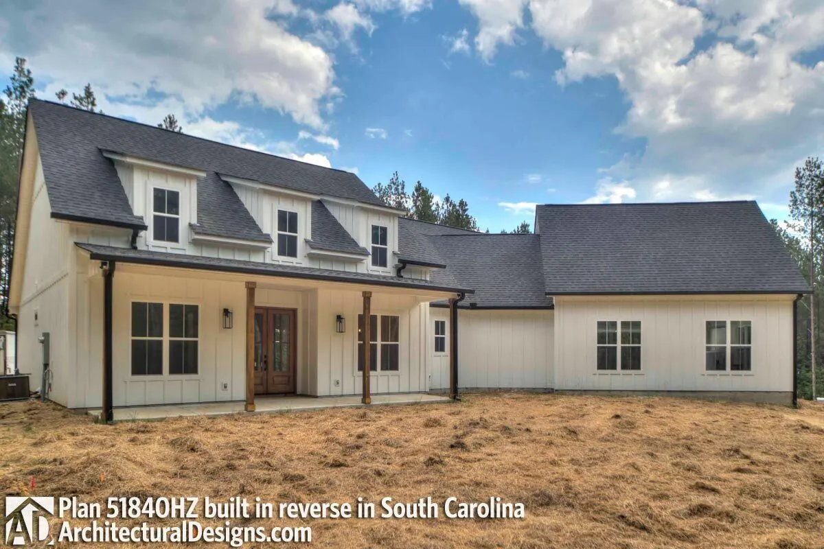 An actual house model with a wood accent door and pillars.