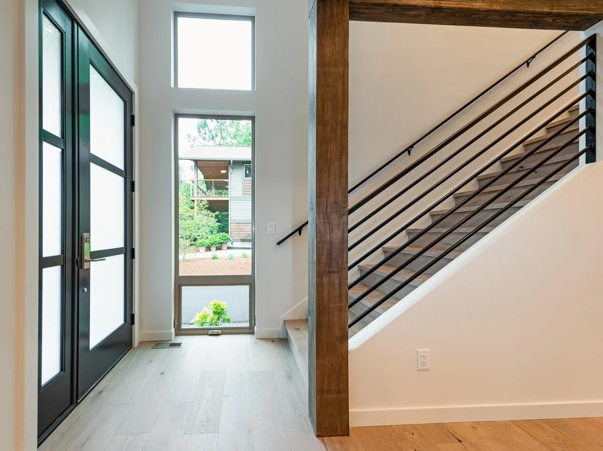 The foyer area has a dark beautiful wood door that leads directly to the stairwell.