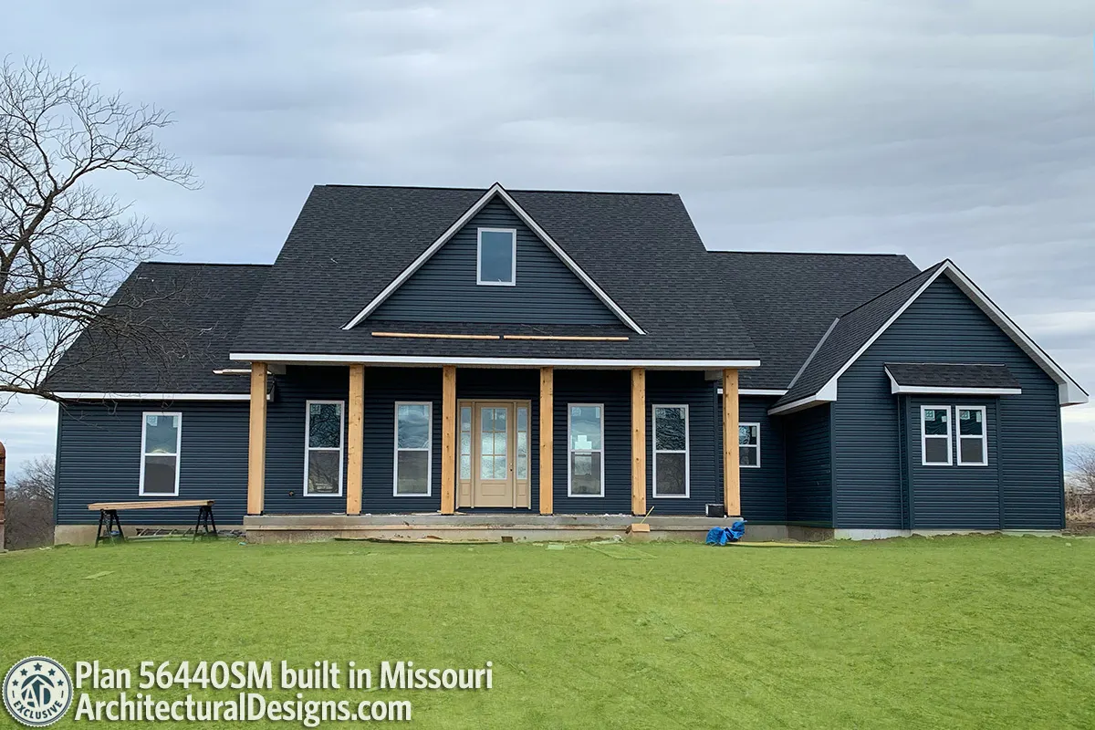 The modern farmhouse is painted an all-over dark gray, which draws attention to the accent wall and highlights the innovative look.