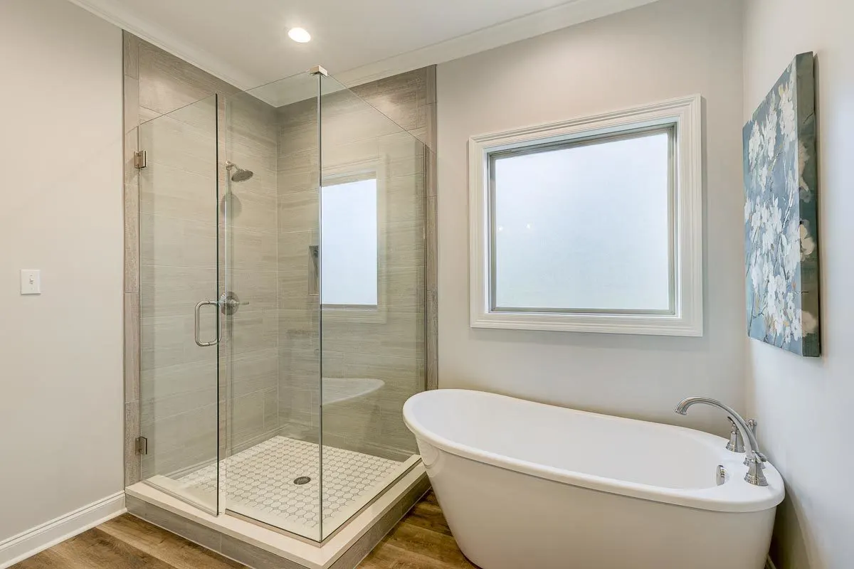 The frosted window in the bathroom suits the glass shower and tub.