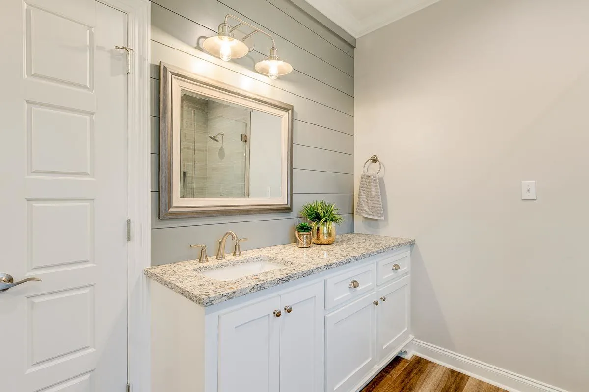 Right vanity space in front of the glass shower area.