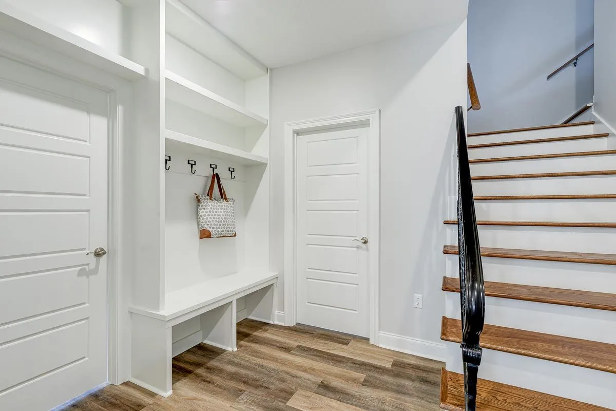 A hanging and locking space near the staircase.