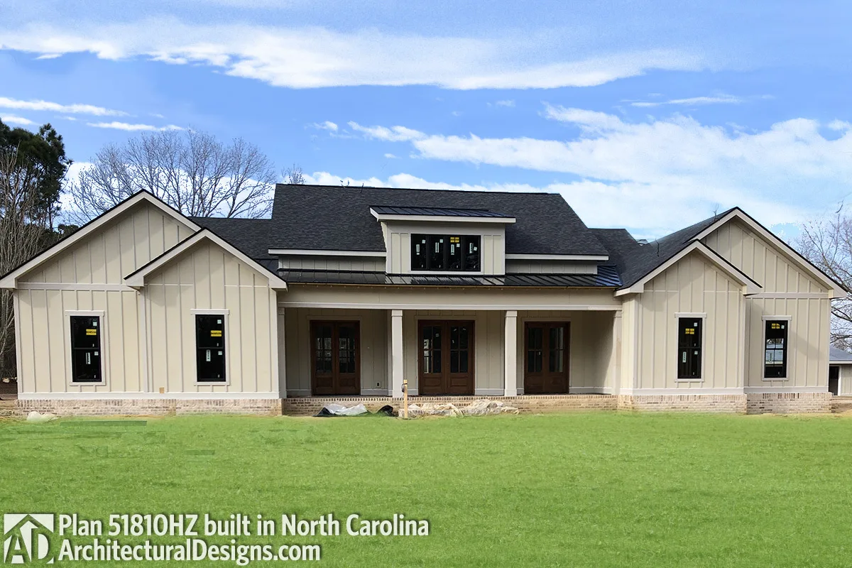 The farmhouse appears substantial since it has complete batten paneling on its walls.