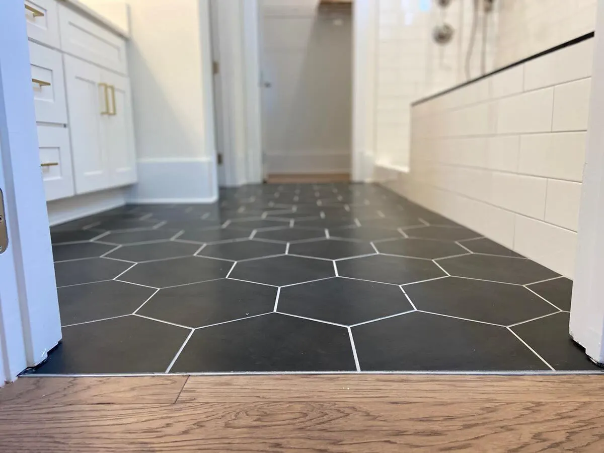 The bathroom section has stunning black patterned tiling.