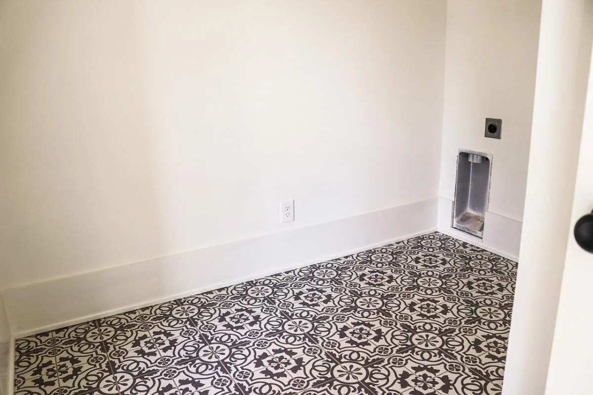 Laundry room with a creatively designed tile floor.