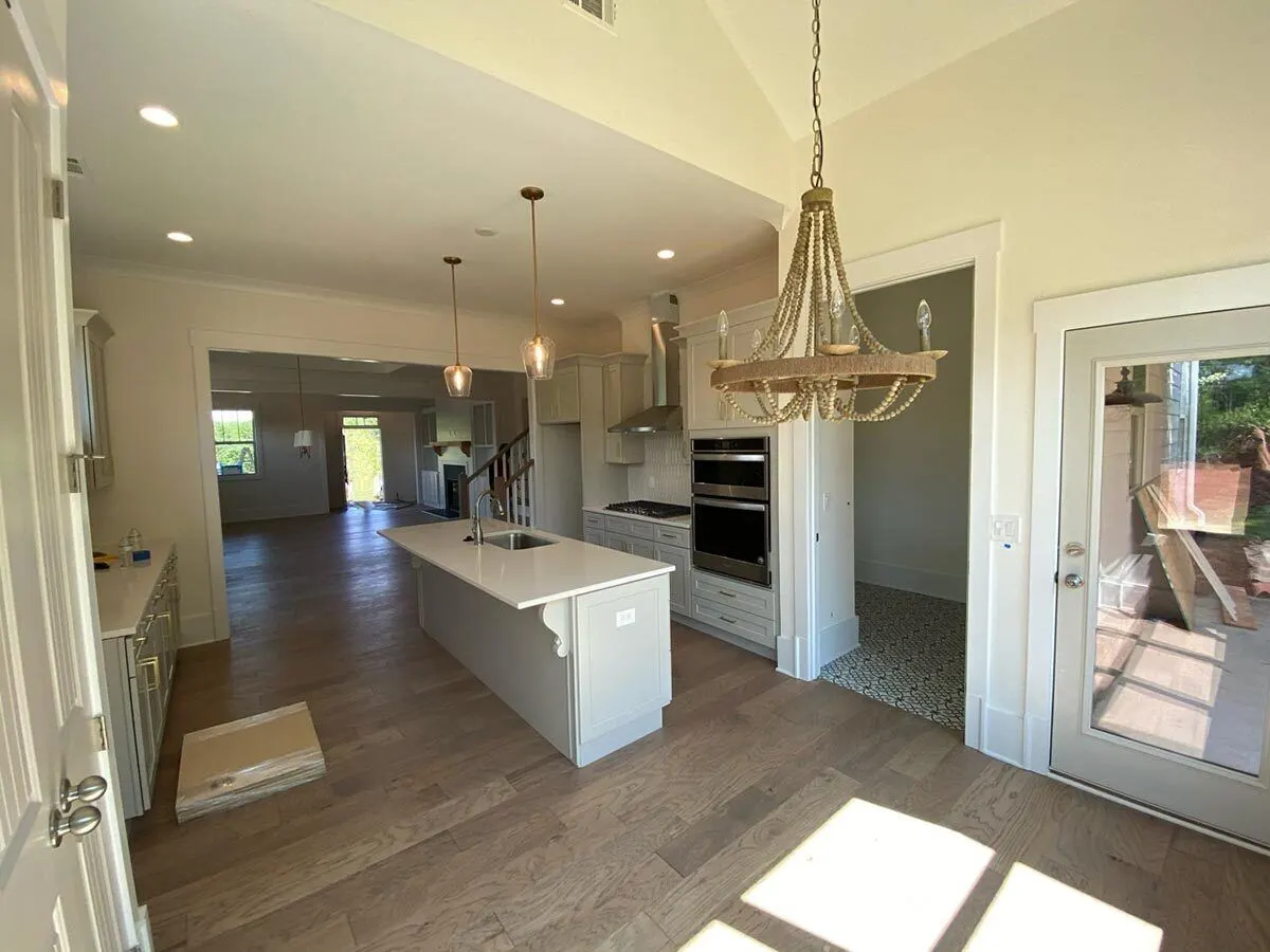 The kitchen area is furnished with elegant light fixtures.